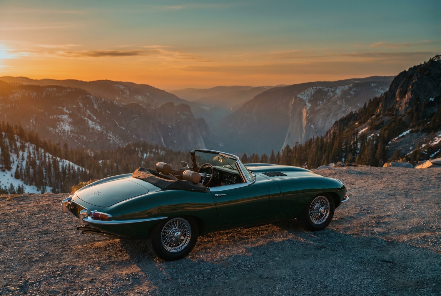 A classic roadster parked at a quiet alpine overlook